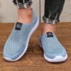 Newness Breathable Mesh Slip On Sneakers in white showcasing the breathable mesh upper and easy slip on design Perfect for everyday wear