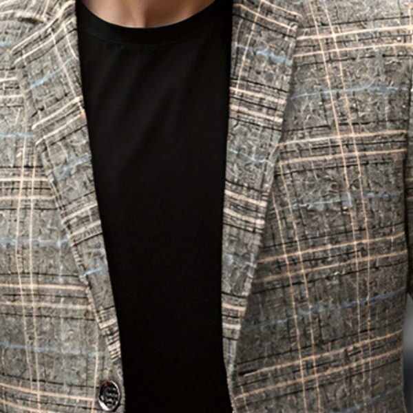The Newness Metropolitan Checkered Blazer in spring style. A close-up showcases the premium fabric and refined, modern look.