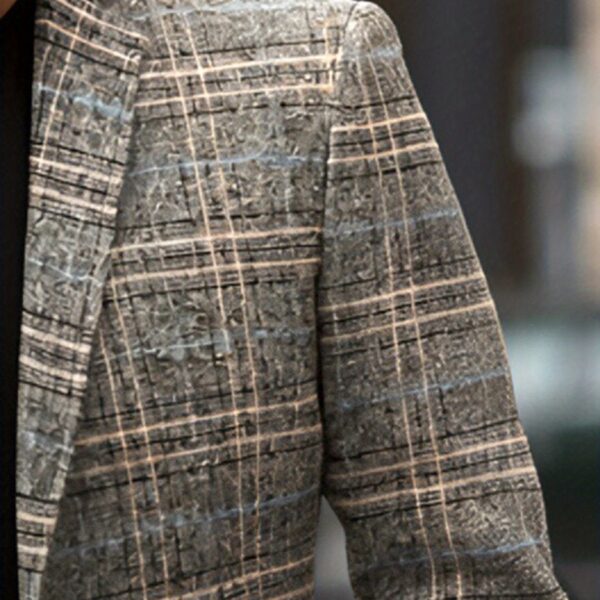 The Newness Metropolitan Checkered Blazer in spring style. A close-up showcases the premium fabric and refined, modern look.