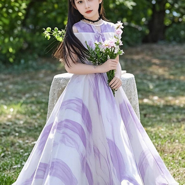 Adorable girl twirling in a flowy, elegant chiffon dress, perfect for summer. The dress is in a beautiful summer garden setting.