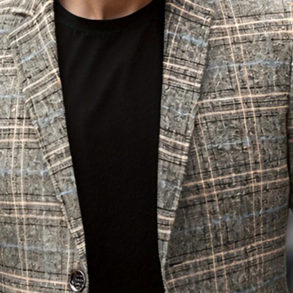 The Newness Metropolitan Checkered Blazer in spring style. A close-up showcases the premium fabric and refined, modern look.