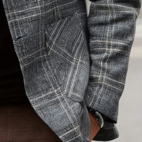 The Newness Metropolitan Checkered Blazer in spring style. A close-up showcases the premium fabric and refined, modern look.