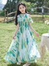 Adorable girl twirling in a flowy elegant chiffon dress perfect for summer The dress is in a beautiful summer garden setting