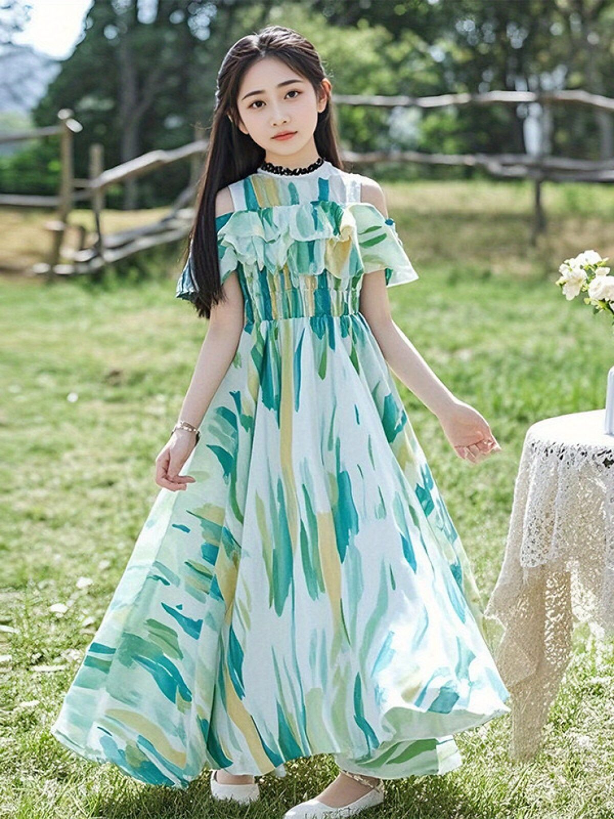 Adorable girl twirling in a flowy elegant chiffon dress perfect for summer The dress is in a beautiful summer garden setting