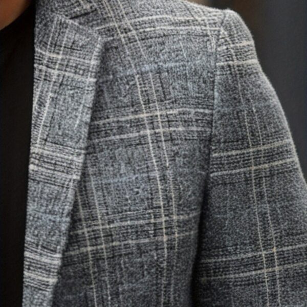 The Newness Metropolitan Checkered Blazer in spring style. A close-up showcases the premium fabric and refined, modern look.