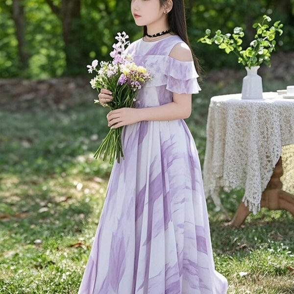 Adorable girl twirling in a flowy, elegant chiffon dress, perfect for summer. The dress is in a beautiful summer garden setting.