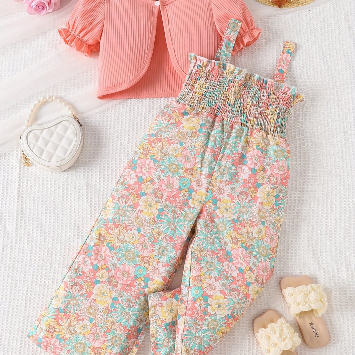 Adorable child wearing Newnesss Summer Bloom Floral Jumpsuit a boho chic floral jumpsuit perfect for sunny days