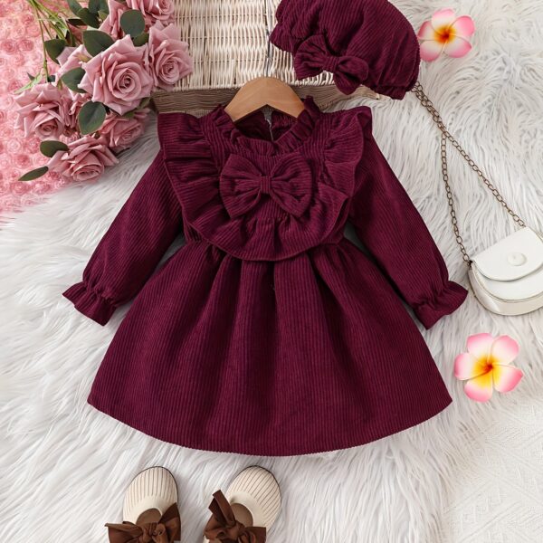 Adorable baby girl wearing a charming corduroy dress, perfect for playtime or special occasions.