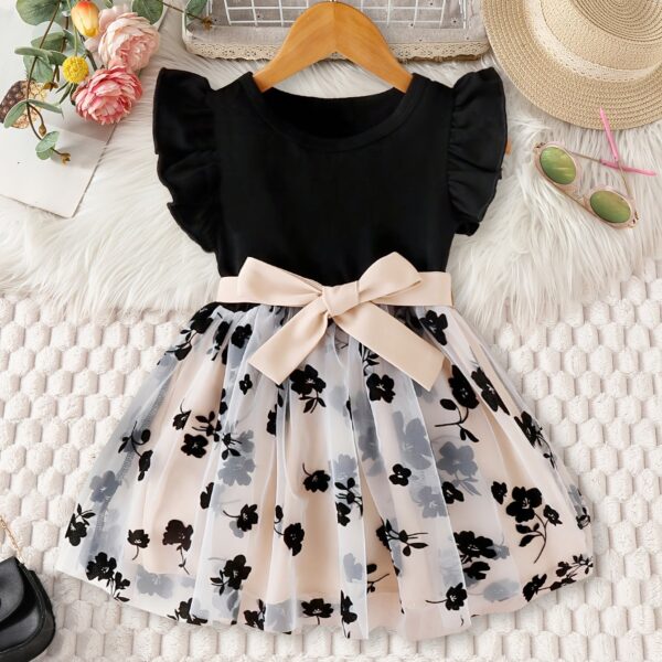 Adorable little girl twirling in a vibrant Summer Bloom floral print dress from Newness, perfect for summer.
